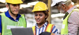 people wearing hard hats using computer